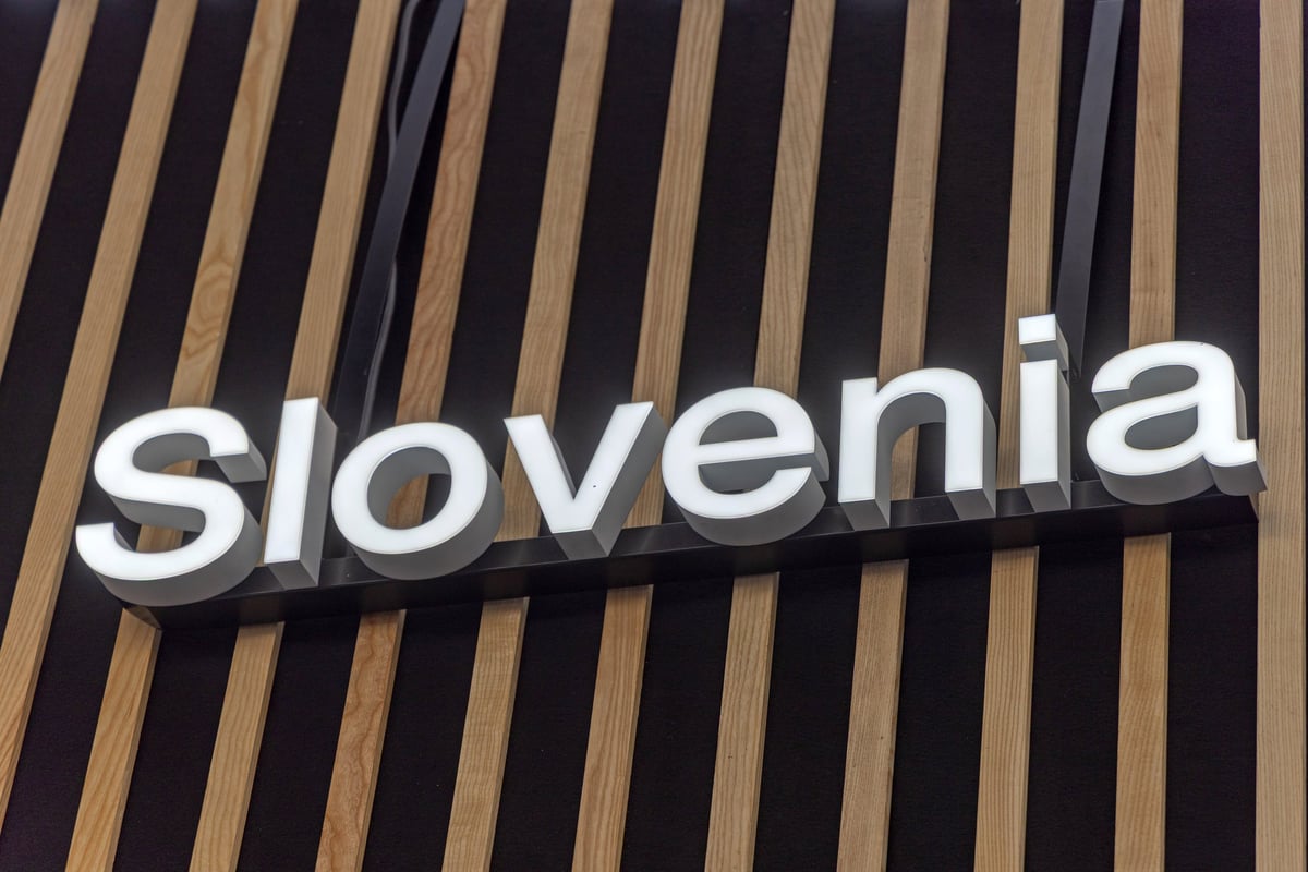 Illuminated white letters sign mounted on a wooden wall